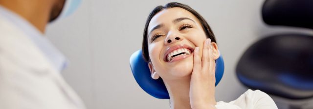 patient smiling in dental chair after treatment